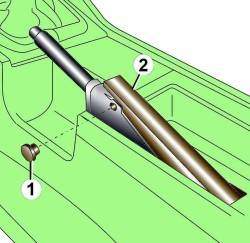 Расположение колпачка (1) зажимного болта и декоративной накладки (2) обивки рычага стояночного тормоза