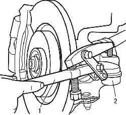 Использование съемника (1) для извлечения шарового шарнира (2) наконечника рулевой тяги из поворотного кулака